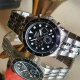 Two silver watches with black faces.