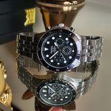 Fossil watch with black face and silver band