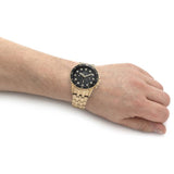 Gold wristwatch on wrist
