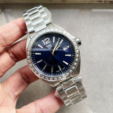 Tag Heuer watch with blue face and diamond bezel