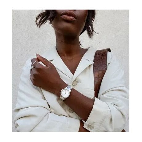 Woman wearing a watch and white jacket