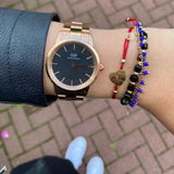 DW00100212-4 Daniel Wellington watch on wrist with bracelets