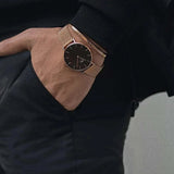 Rose gold watch and bracelet on wrist.