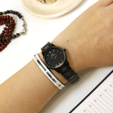 Black Daniel Wellington watch and bracelet on wrist