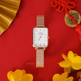DW00100431-3 Rose Gold Rectangular Watch on Red Background