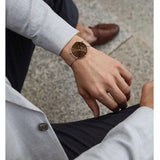 Close-up of a man wearing a brown watch