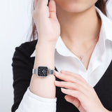 Woman wearing silver square watch