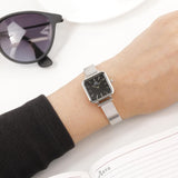 Daniel Wellington DW00100522 square watch on wrist with sunglasses