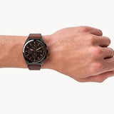 FS5798 Fossil watch on wrist with brown leather strap.