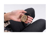 Gold Guess watch G-GW0439L2 held in hand