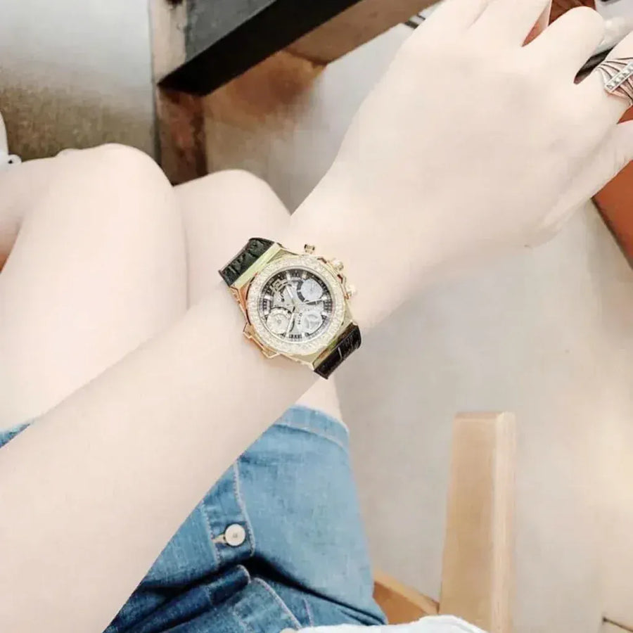 Guess GW0553L4 watch on wrist, black leather strap, gold face