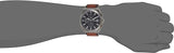 JYabt11 Watch on wrist with brown strap.
