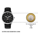 Fossil watch with black strap, near 10 rupee coin for size comparison.