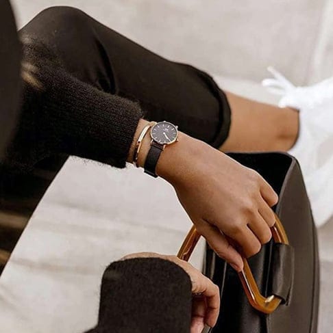Woman's hand with watch and bracelet, holding a bag. (MP000000020523741)