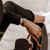 Woman's hand with watch and bracelet, holding a bag. (MP000000020523741)