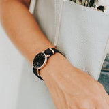 Black watch with rose gold face on wrist