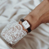Daniel Wellington watch on wrist with lace sleeve