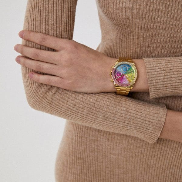 Rainbow dial watch on wrist.