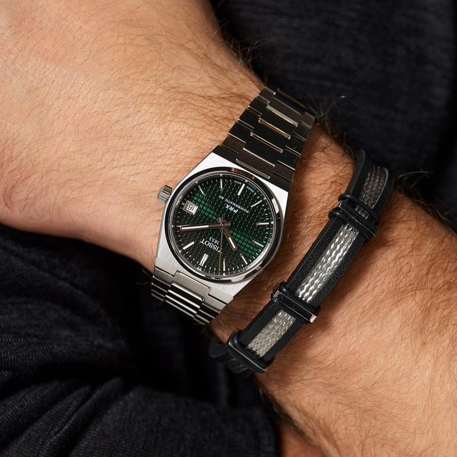Tissot PRX watch with green dial and bracelet on wrist
