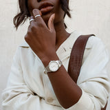 Woman wearing silver watch and rings