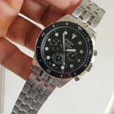 Fossil watch with black face and silver band