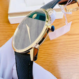 Movado men's watch with gold case and black strap