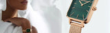 Woman wearing rose gold watch with green face, e3n9jf311nu3wc75xj3gyv6z83q7uli9.