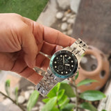 Fossil watch held in hand, product image