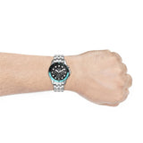 FS5827-3P watch on wrist with black and turquoise accents