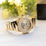 Guess women's gold watch with crystals and golden strap