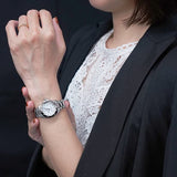 Woman wearing a silver wristwatch, l_02e84f38-f4a5-4ed3-a68a-cb292b09070b