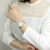 Woman wearing a silver wristwatch