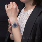 Woman wearing a silver watch, detail image l_1_cd11ec5a