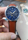 Fossil watch with blue face and brown leather strap