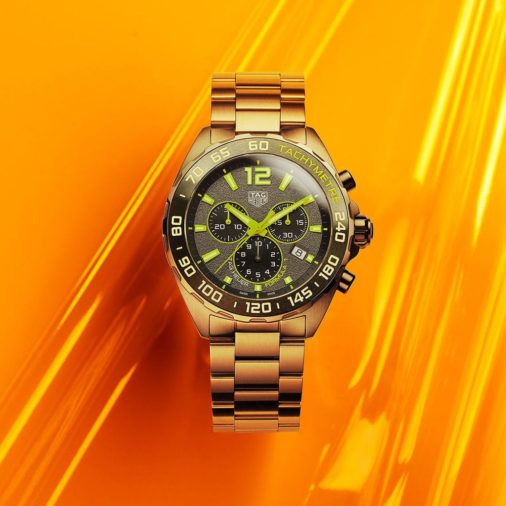 Tag Heuer Formula 1 CAZ101AGBA0842 gold watch on orange background