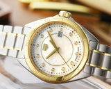 Tag Heuer watch with gold and silver accents.