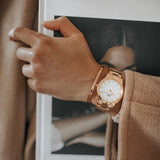 Rose gold watch and bracelet on wrist