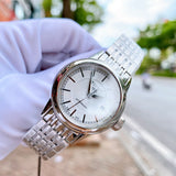 Tissot automatic watch held by gloved hand