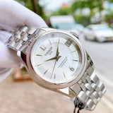 Tissot watch with white face and silver band