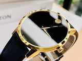 Movado watch with black face and gold accents