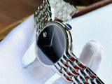 Movado watch with black face and silver band