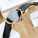 Movado watch with black strap and rose gold case.