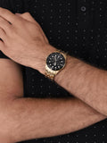 Fossil FS5836 men's gold watch with black dial on wrist